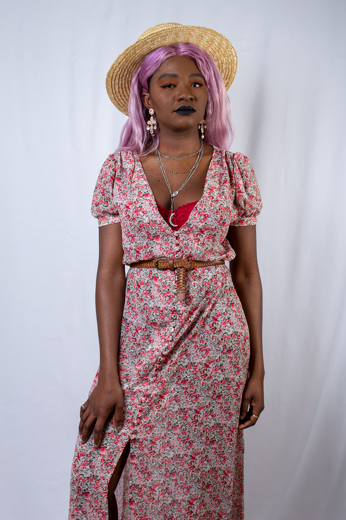 Mariama Rebecca with pink hair wearing a floral dress from Nasty Gal.